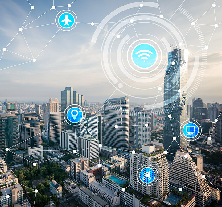 City skyline with IoT Connectivity services icons overlaid.